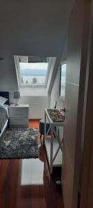 a bedroom with a bed and a desk and a window at Apartment Illyricum in Bol