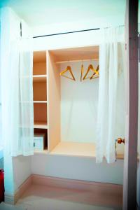 a closet with white curtains and hangers at Hazz Oda in Cesme