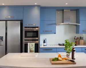a kitchen with blue cabinets and a counter top at Downalong in Polzeath