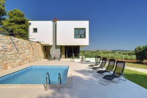 a villa with a swimming pool and some chairs at Villa Martina in Štinjan