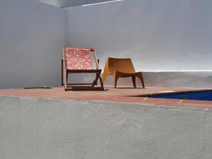 two chairs sitting on a floor in a room at A Casa da avó Custodinha in Bias do Norte