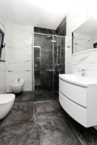 a bathroom with two sinks and a shower at Apartments Villa Casia in Srima +58 photos