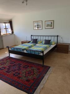 a large bed in a bedroom with a rug at Ferienwohnung Agnes Mayer in Riedenburg