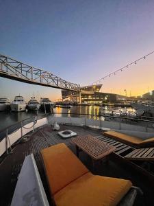 a deck of a boat with a table and a bridge at Boat ALOHA in Barcelona