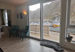 a living room with a view of a marina at Karlotte's apartment in Ballstad