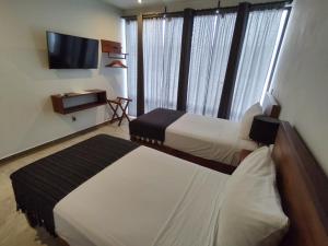 Postel nebo postele na pokoji v ubytování Hotel Muyu Tulum