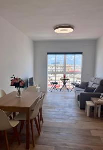 a living room with a table and a couch at GATU El Mirador de la Viña in Cádiz