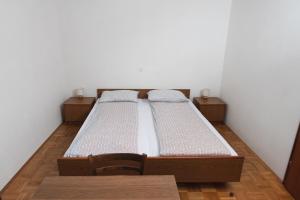 a twin bed in a room with two chairs at Roja House in Soča