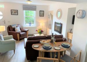 a living room with a couch and a table at Coorie Doon in Cairnbaan