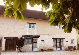 a large brick house with two doors and a porch at Gites Le Clos de Lamie avec 2 piscines privées in Fossemagne