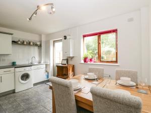 a kitchen and dining room with a table and chairs at 16 Mythern Meadow in Bradford on Avon