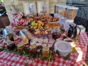 a picnic table with food on a red and white checked table cloth at Valley View dullstroom - check in at The Highlander Hotel in Dullstroom