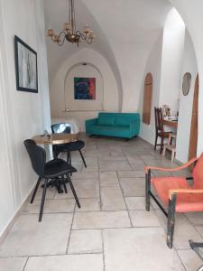 a living room with a couch and a table and chairs at Legatia in Jerusalem