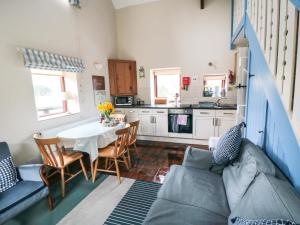 Una cocina y una sala de estar con una mesa y un sofá. en Farndale, en Whitby 15 fotos más