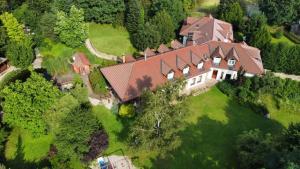 an aerial view of a large house on a green field at Ivanek guest house in Zvíkovské Podhradí