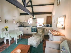 a living room with a table and a kitchen at Glaisdale in Whitby