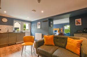 a living room with a couch and a kitchen at Raniven in Oban