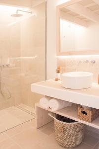 a white bathroom with a sink and a shower at 120 Hotel Boutique - Adults Only in Ciutadella