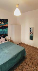 a bedroom with a bed and a white cabinet at Nicolai63 in Bari