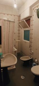 a bathroom with two sinks and a tv in it at Nicolai63 in Bari