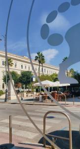 a large metal sculpture in front of a building at Nicolai63 in Bari +16 photos