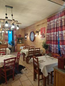 a restaurant with tables and chairs in a room at Le Pourquoi pas in La Bourboule