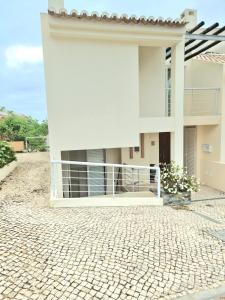 een groot wit gebouw met een stenen oprit bij Varandas do Carvoeiro in Carvoeiro +10 foto's