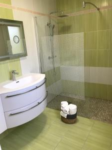 a bathroom with a sink and a glass shower at BlackBerry Cottage - Maison de vacances - with WIFI in Lessay +41 photos