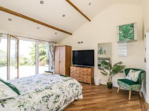 a bedroom with a bed and a flat screen tv at Fairfield in Ludlow