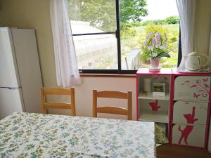 a kitchen with a table and a refrigerator and a window at Cat Villa Kawajimamachi in Kawagoe +26 photos
