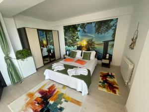 a bedroom with two beds and a large window at DreamView Mamaia SummerApt in Mamaia