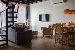 a living room with a ladder and a table and chairs at Punda City Centre Penthouse in Willemstad