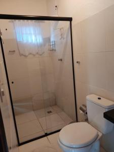 a bathroom with a shower and a toilet at Pousada Céu Azul in Sao Jorge