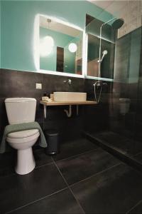 a bathroom with a toilet and a sink at Central urban studio A in Athens