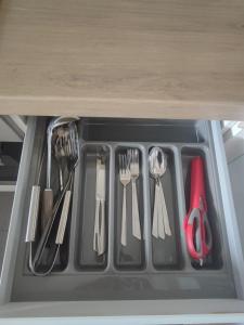 a drawer filled with utensils in a refrigerator at Chic et moderne+Wifi+Netflix in Argenteuil