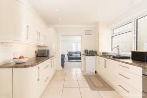 a kitchen with white cabinets and a counter top at 6 Woodville in The Mumbles