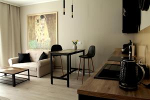 a living room with a couch and a table at Capitals Residence in Oświęcim
