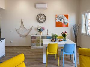 a kitchen and dining room with a table and chairs at Vista Mare Borgo Peri in Imperia