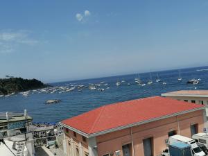 a group of boats in the water behind a building at Casa sul mare in Procida +8 photos