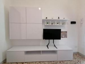 a television sitting on a white shelf in a room at Casa sul mare in Procida
