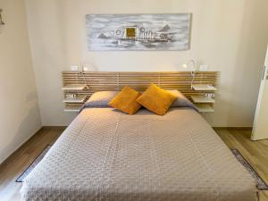 a bedroom with a large bed with yellow pillows at Vista Mare Borgo Peri in Imperia