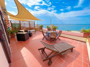 a patio with a table and chairs on a balcony at Vista Mare Borgo Peri in Imperia +50 photos