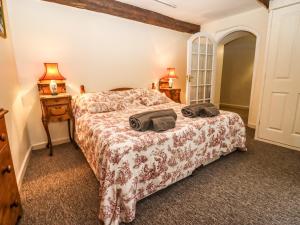 Un dormitorio con una cama con dos bolsas. en Dollar Ward House Basement, en Cirencester