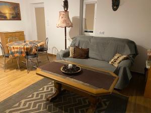 a living room with a couch and a table at Bednarzówka Hajnówka in Hajnówka +12 photos