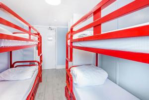 two red bunk beds in a small room at Astor Hyde Park Hostel in London
