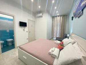a bedroom with a large bed and a bathroom at Il Vicoletto in Naples
