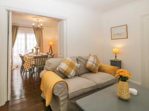 a living room with a couch and a table at Summer Cottage in Torquay