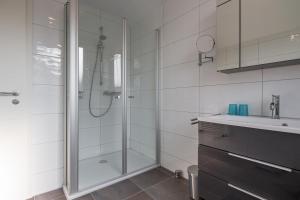 a bathroom with a shower and a sink at Louise am Meer in Norderney +7 photos