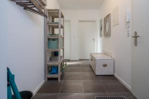 a room with a shelf and a tiled floor at Louise am Meer in Norderney