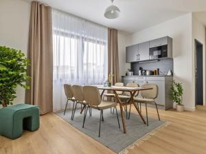 a kitchen and dining room with a table and chairs at limehome Bodenmais Bahnhofstraße in Bodenmais